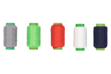 Colored spools of thread on a white background