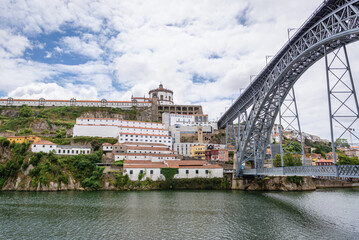 Fototapeta na wymiar Dom Luis I Bridge over Douro River between cities of Porto and Vila Nova de Gaia, Portugal. VIew with Monastery of Serra do Pillar