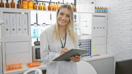 In a bustling lab, a confident young blonde woman, a radiant scientist with a beautiful smile, stands passionately taking notes, absorbing the magic of science around her.