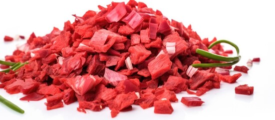 A colorful pile of chopped red peppers, a vibrant ingredient in many dishes, sits on a clean white surface. These natural foods add flavor and color to various cuisines