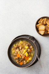 Oyster mushroom soup in plates, soup made from Pleurotus mushrooms and potatoes, carrots and spices, top view, copy space