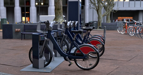 Generic Electric bicycle charging station. Shared electric bikes parked for rent on city street