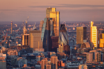 The diverse architecture of the office skyscrapers at the City of London, England, during golden sunrise
