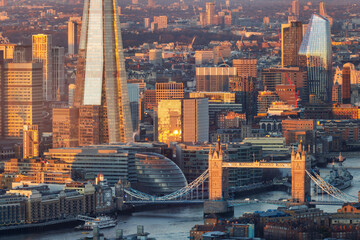 Elevated close-up view of the London architecture with Tower Bridge and London Bridge area during a golden sunrise