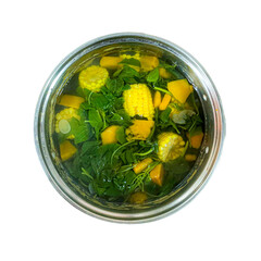 indonesian spinach and carrot clear soup in white bowl. sayur bening bayam