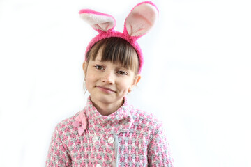 Ten-year-old girl with bunny ears on her head celebrates Easter