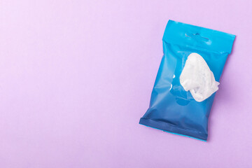 Packaging of wet wipes on a purple background. An open pack of hand and body wipes. Mockup. A clean...