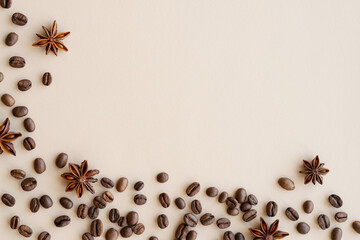 Coffee beans and spices on a beige background. Top view. Copy space
