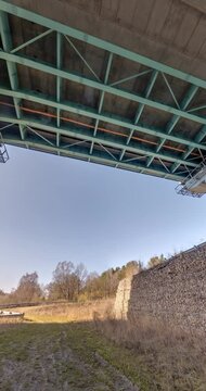loop rotation under steel frame and concrete construction huge car bridge across the wide river.