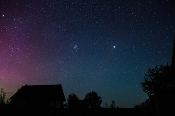 Starry sky with bright stars outside the city in the mountains, no one, the Milky Way. Silhouettes...