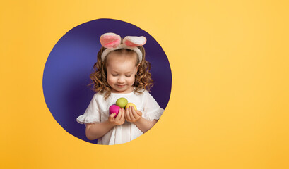 Girl with painted eggs