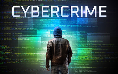 Faceless hacker on code background