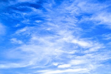 blue sky background with tiny white clouds