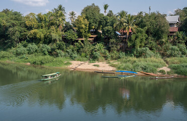 The Nam Khan River, which flows into the Mekong River, is located in Luang Prabang, Laos, Asia