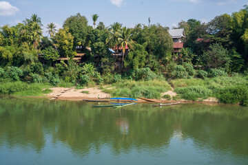 The Nam Khan River, which flows into the Mekong River, is located in Luang Prabang, Laos, Asia
