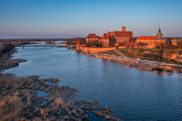 Malbork castle over the Nogat river at sunset, Poland - 756560964