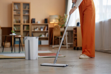 Cropped shot of unrecognizable woman mopping floors at home and enjoying Spring cleaning copy space