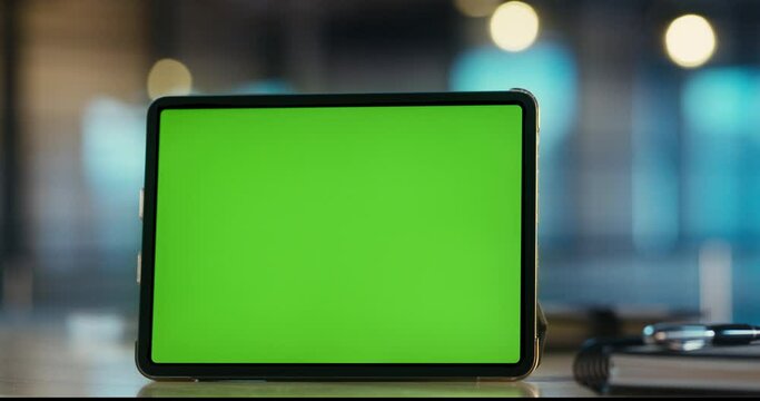Digital tablet with green screen on the desk in the office