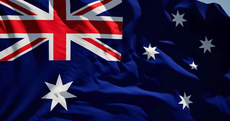 Close-up of the national flag of Australia flutters in the wind on a sunny day