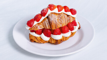 Croissant with raspberries on plate isolated