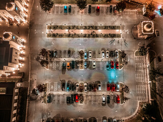 Top down view of a parking lot with cars at night at a mosque in Malaysia.