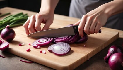 Obraz na płótnie Canvas Female hand using knife to slice fresh red onion on chopping board, close-up