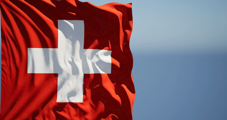 Close-up of the national flag of Switzerland flutters in the wind on a sunny day