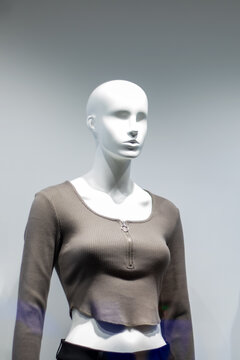 Female mannequin in gray jacket close up