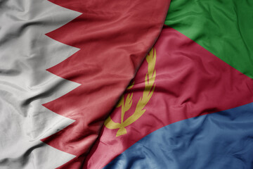 Fototapeta premium big waving national colorful flag of eritrea and national flag of bahrain.