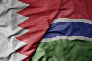 big waving national colorful flag of gambia and national flag of bahrain.