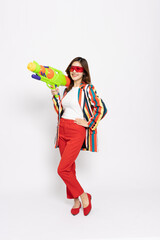 Young Asian woman in summer colorful striped shirt suit holding water guns plastic for Songkran festival in Thailand isolated on white background - 756579574