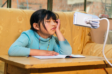 latina girl tired of school homework in bolivia - education concept