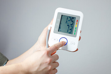 Man check blood pressure monitor and heart rate monitor with digital pressure gauge. Health care and Medical concept