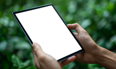 Touch screen tablet in hands in front of nature green background