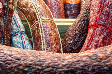 Different tasty sausages as background, closeup view, selective focus.