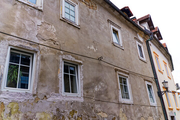 Sightseeing at the old town of City of Ljubljana with gray weathered facades of historic houses at...