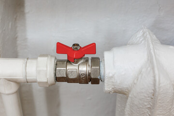 The ball valve with the red handle is open. Shut-off valves for the apartment heating system.