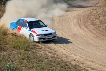 Fototapeta na wymiar Rally Car in a Turn and a Cloud of Dust 21