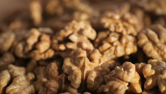 Walnut kernels rotating. walnut close up lies under beams of the sun. Walnut close up. product rich in minerals and vitamins. Macro 4K