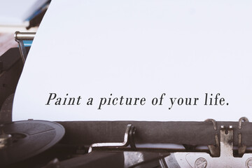 Paint a picture of your life text on white paper with blue typewriter.