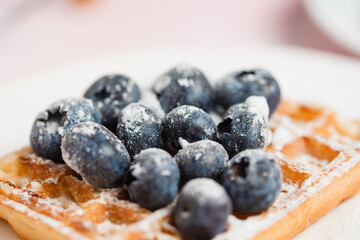 Blueberries arranged on a Belgian waffles , Belgian dessert