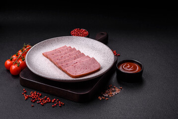 Delicious canned pink ham with salt, spices and herbs