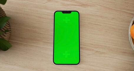 Smartphone place on kitchen table, Green screen telephone, Close up display mobile phone with mock up, Chroma key monitor - 756591791
