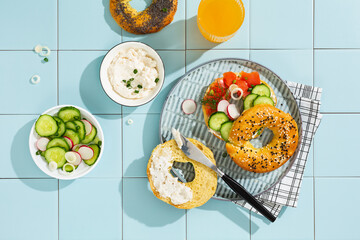 Bagel with cream cheese, cured salmon and dill, top view.