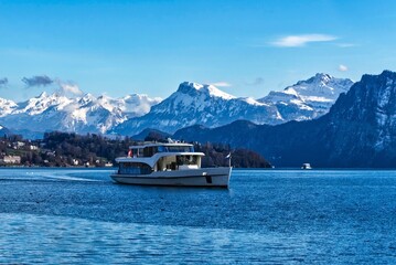 Cruise ship on Lake Lucerne near Lucerne in winter with mountains in the snow.         