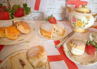 Celebrating St Georges day  England   afternoon team  vintage  victoria  sponge  strawberries and  cream scones bunting   england flag 