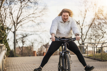 Woman Having Fun and Riding Bike Down Brick Road
