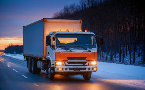 Truck on road. Wintertime, evening view