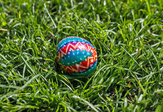 Easter decorated egg on meadow