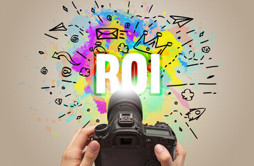 Close-up of a hand holding digital camera with abstract drawing
